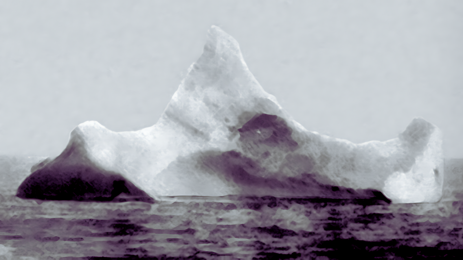 The iceberg thought to have been hit by Titanic, photographed on the morning of 15 April 1912. Note the dark spot just along the berg's waterline, which was described by onlookers as a smear of red paint thought to be of a ship.