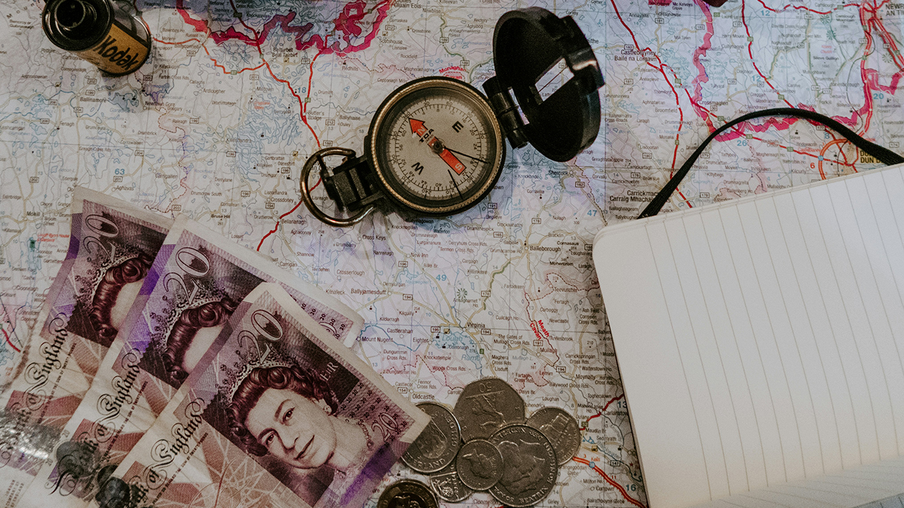 Denise Jans Unsplash - Map, compass and money for an escape