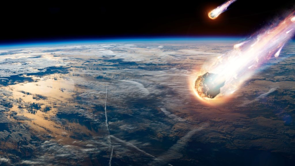 A comet, an asteroid, a meteorite glows, enters the earth's atmosphere. Attack of the meteorite. Meteor Rain. Kameta tail. End of the world. Elements of this image furnished by NASA. 