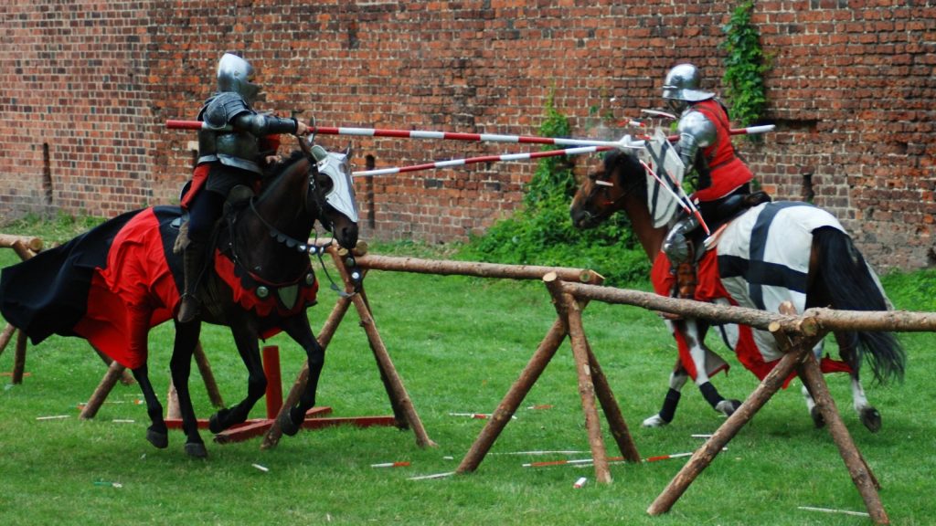 Medieval knights jousting during a renaissance fair tornament.