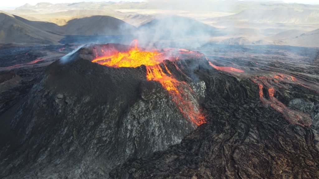 A landscape of lightening erupting from Mauna Loa Volcano in Hawaii with smoke and a hazy sky