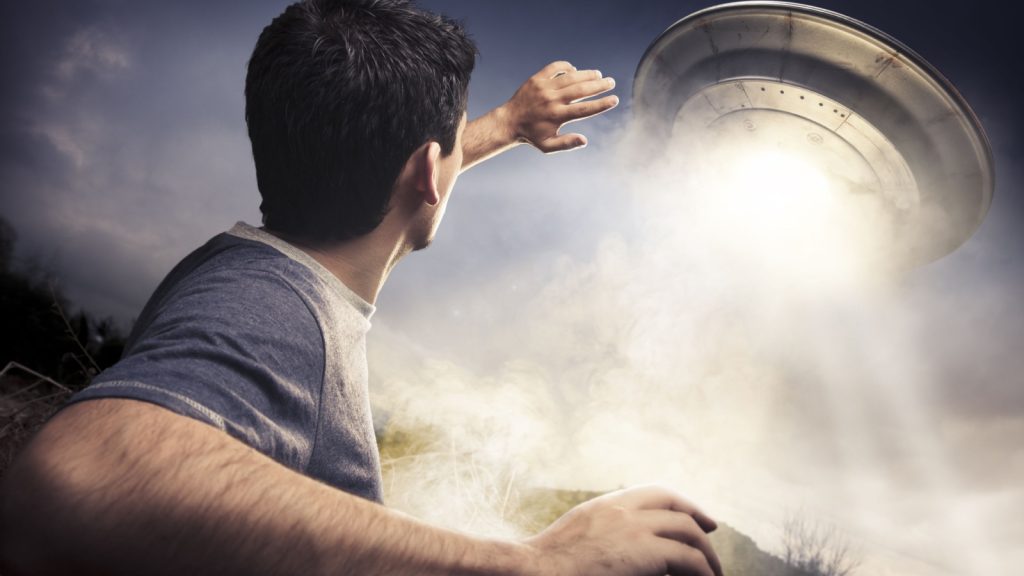 Man looking at a UFO
