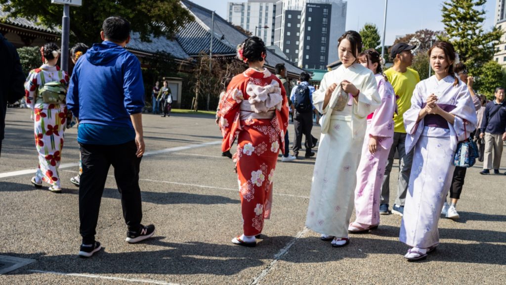 Group of Women in Colorful Kimonos Walking at a Temple Festival, local custom