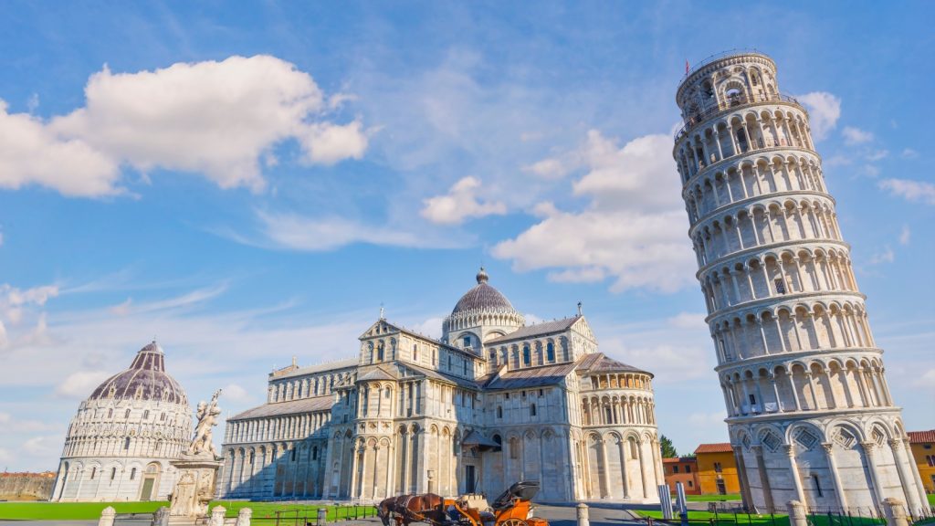 Horse with carriage on the square with Pisa leaning tower and cathedrals, Italy