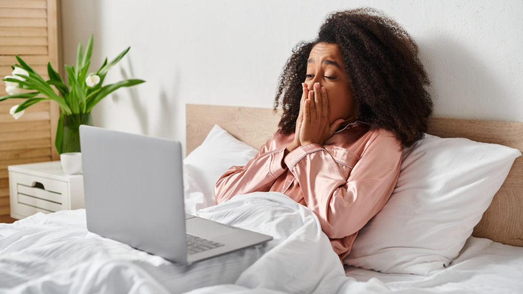 person in bed with laptop