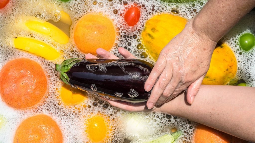 Fruit and vegetables washing in soapy water for coronavirus disinfection. vinegar. 