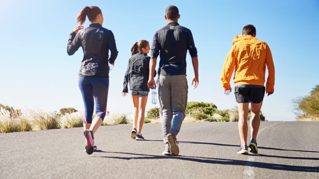 People, friends and walking exercise as group or running community for club sports, hiking or nature. Men, women and back for healthy cardio in California for outdoor training, workout or athlete