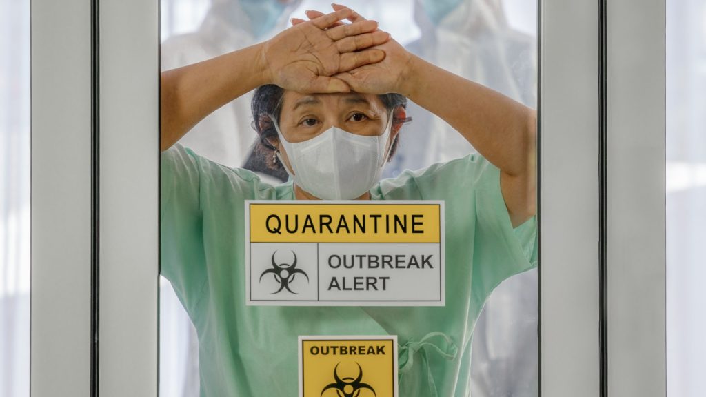 coronavirus covid 19 infected patient in coronavirus covid 19 quarantine room with quarantine and outbreak alert sign at hospital with blurred disease control experts, coronavirus outbreak control.