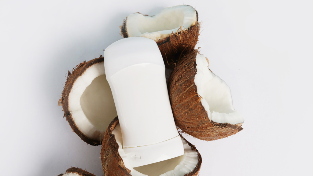 Deodorant and coconut on white background