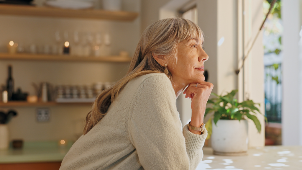 Senior woman smiling and looking out the window