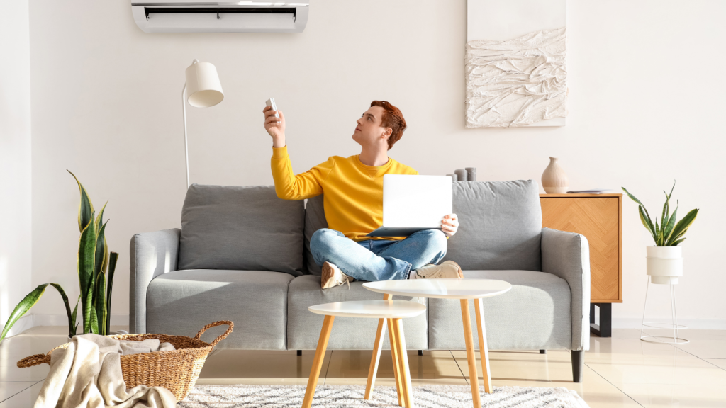 Man turning on air conditioner