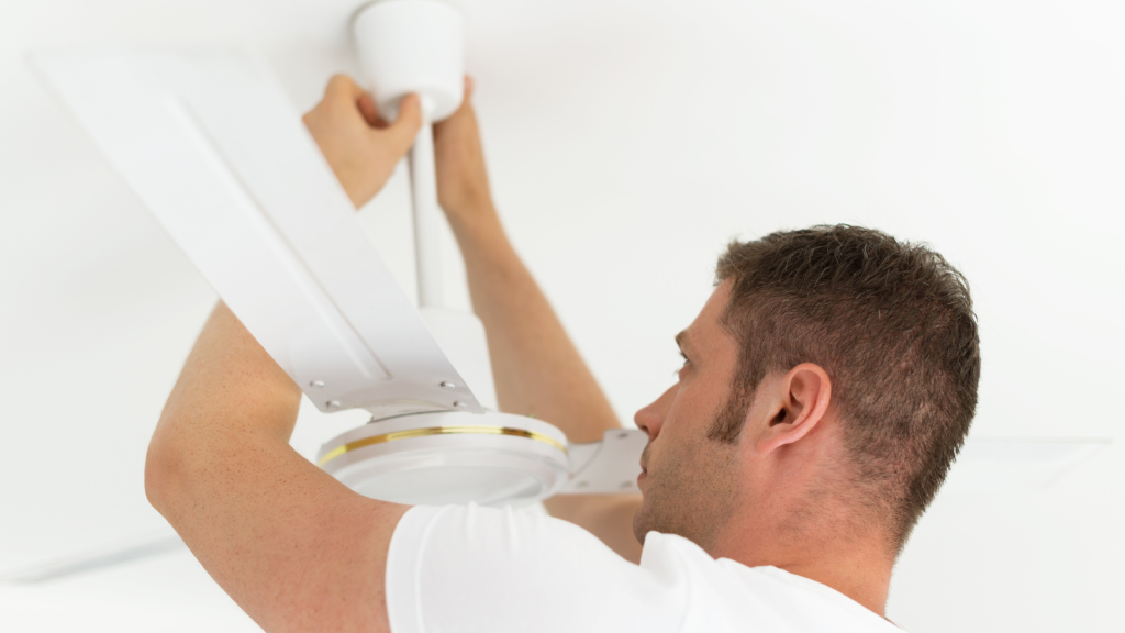 Man installing a ceiling fan