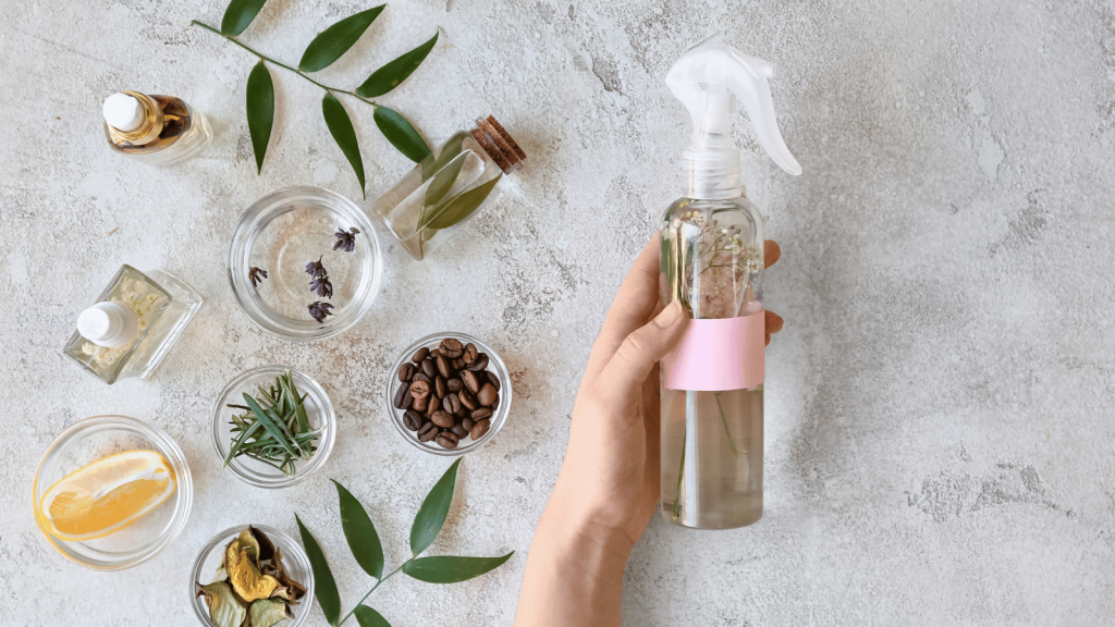 Person holding a spray bottle with herbs