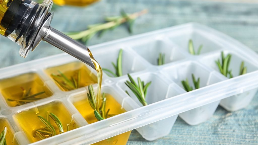 pouring olive oil into ice cube