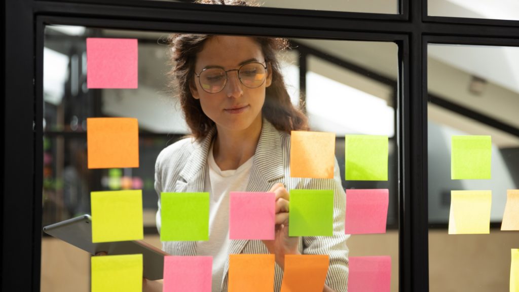 woman taking small notes of large info