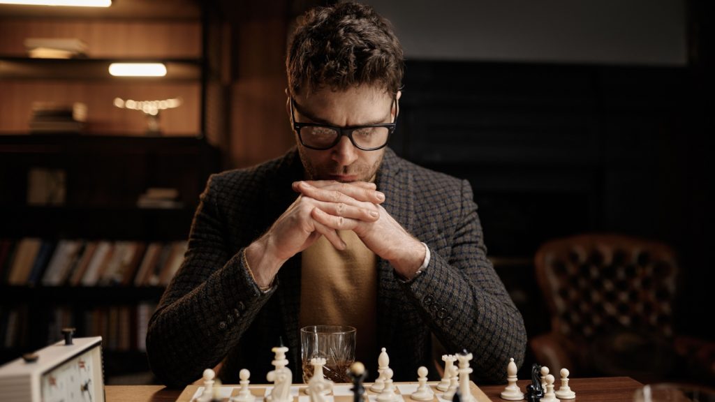 man playing chess seriously