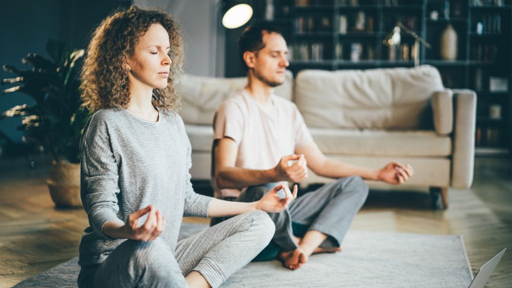 Couple practicing mindful breathing in the morning