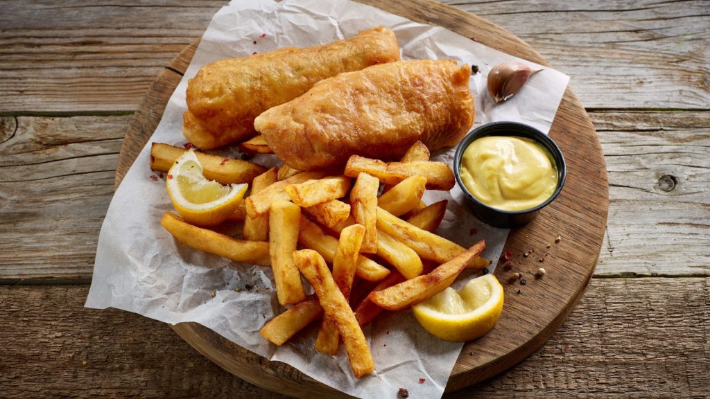 Fish and chips on wooden plate