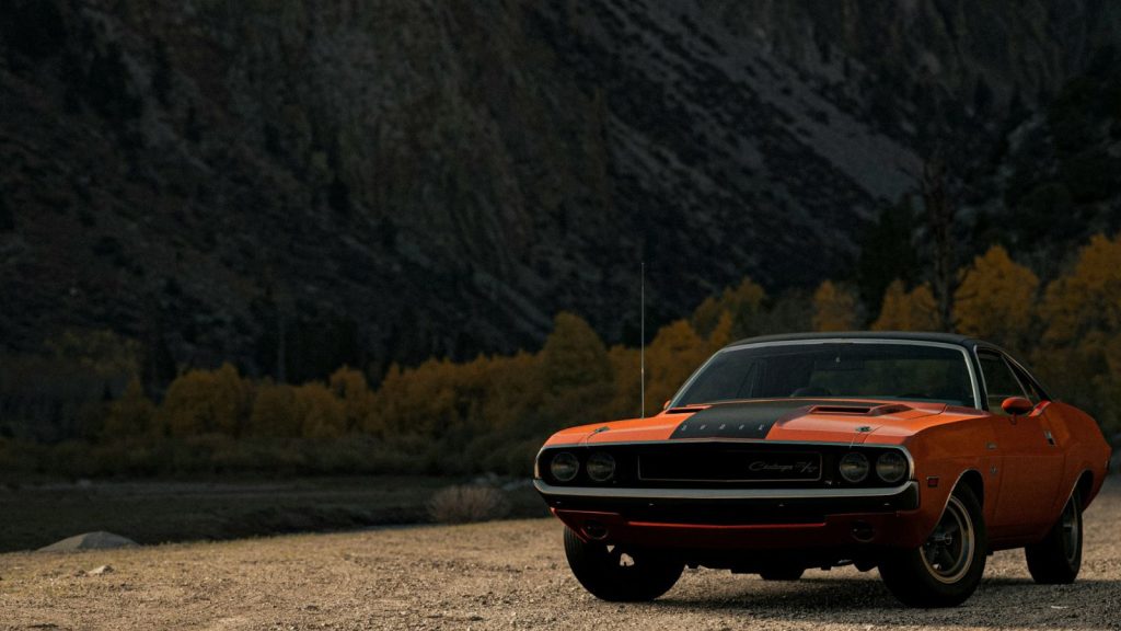 Dodge Challenger parked at the base of the mountain