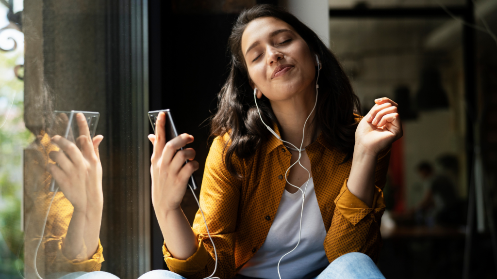 Young woman sitting and listening the music