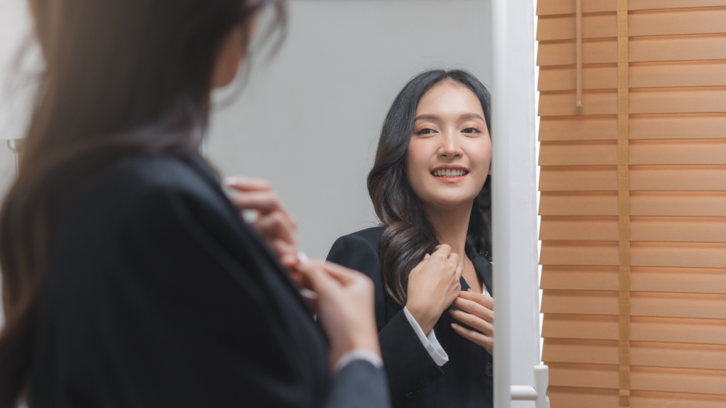 getting dress for work looking at mirror at home