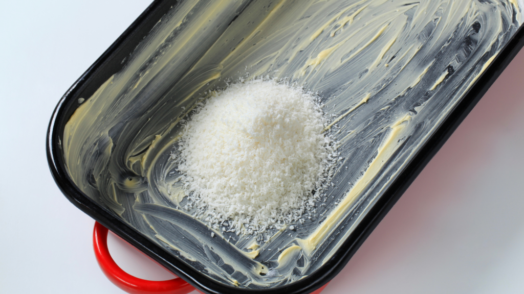 heap of desiccated coconut in greased baking pan