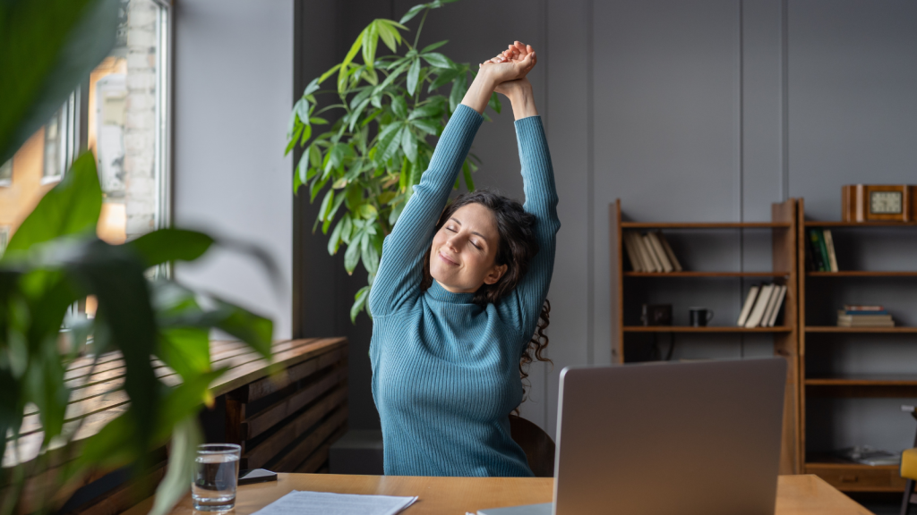 woman warming up body and muscles at workplace