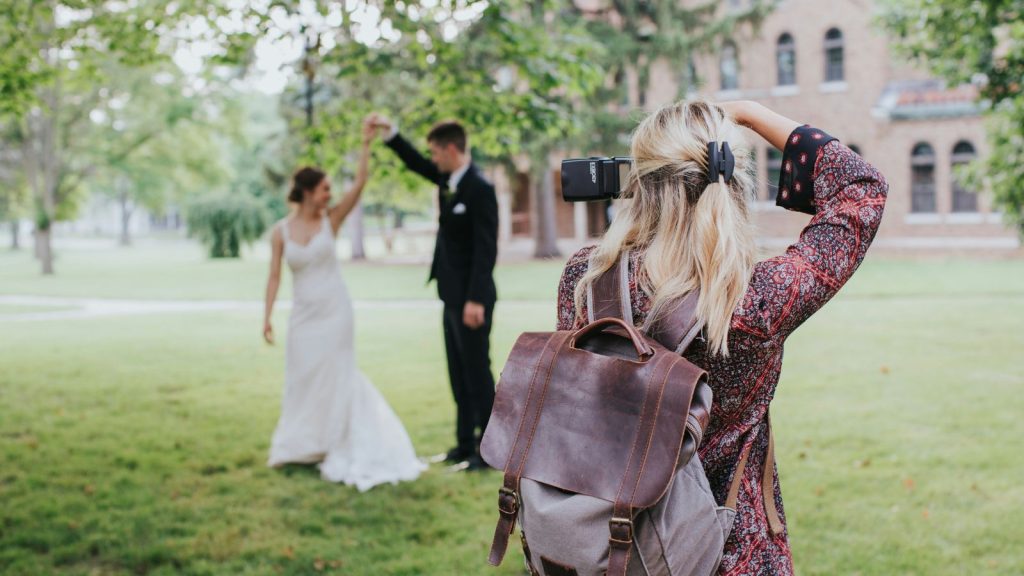 A photographer taking pictures of wedded couple