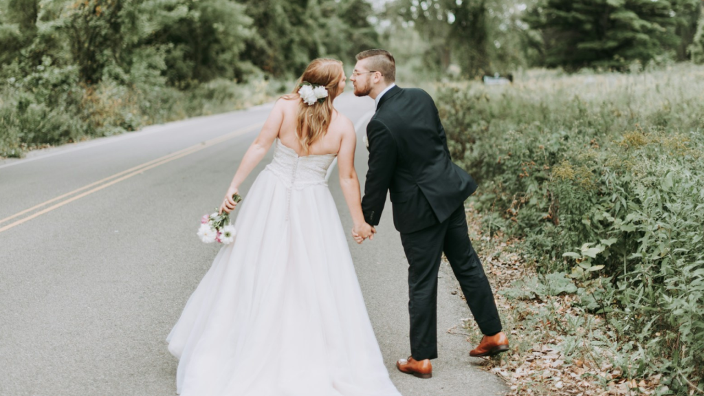 Bride and groom kissing on the highway