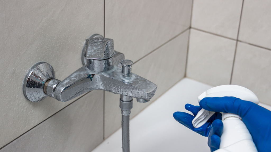 Close-up of the shower faucet and showerhead cleaning process from lime scale