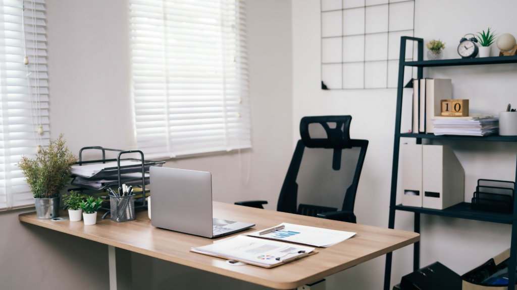 Image of a minimalist office desk with few potted artificial plant decorations