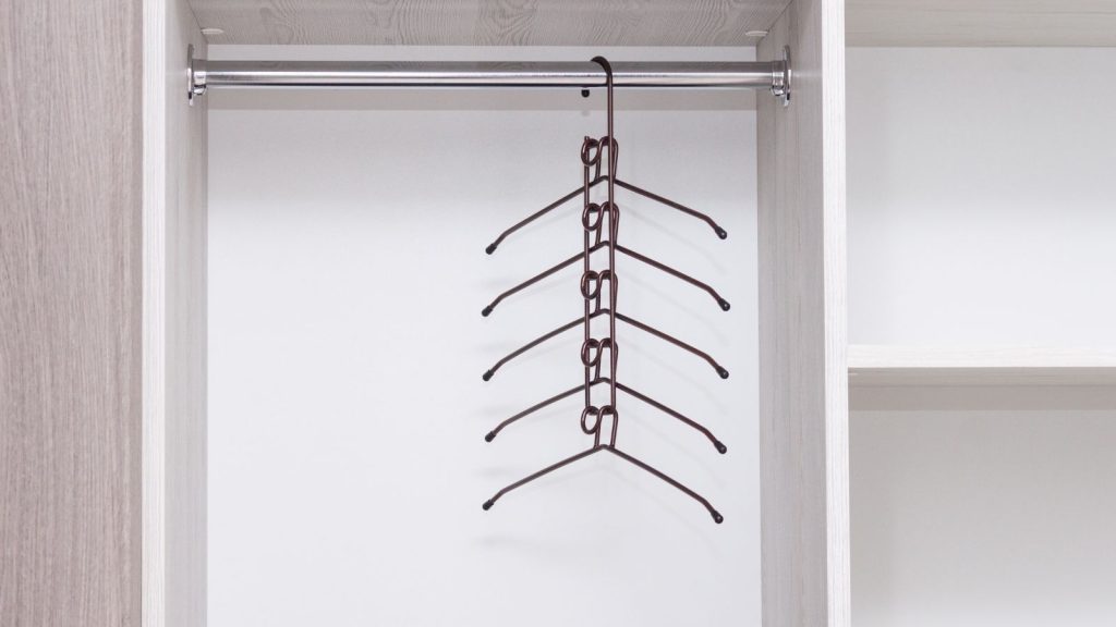 Image of a closet featuring multi-tiered hangers that maximize vertical space