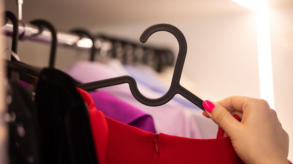 Image of a closet with clothes neatly hung on slimline hangers