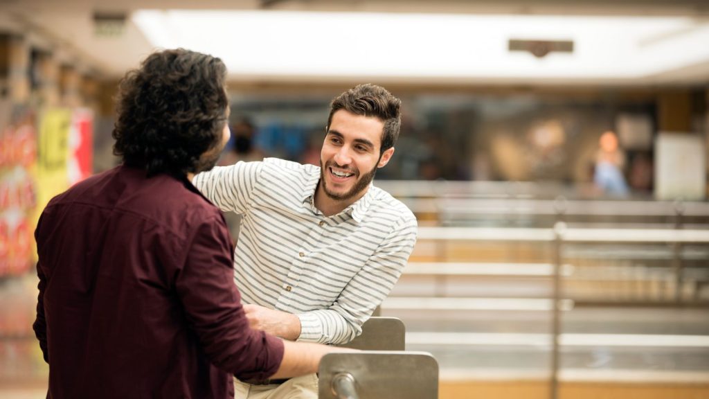 Image of a person leaning slightly forward during a conversation