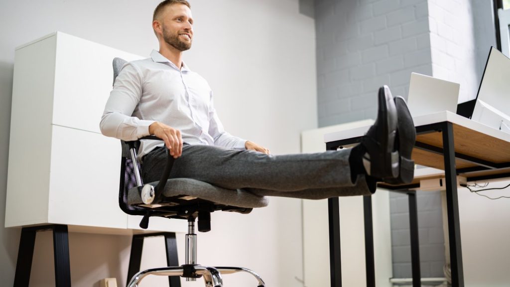 Man at the office stretching his legs