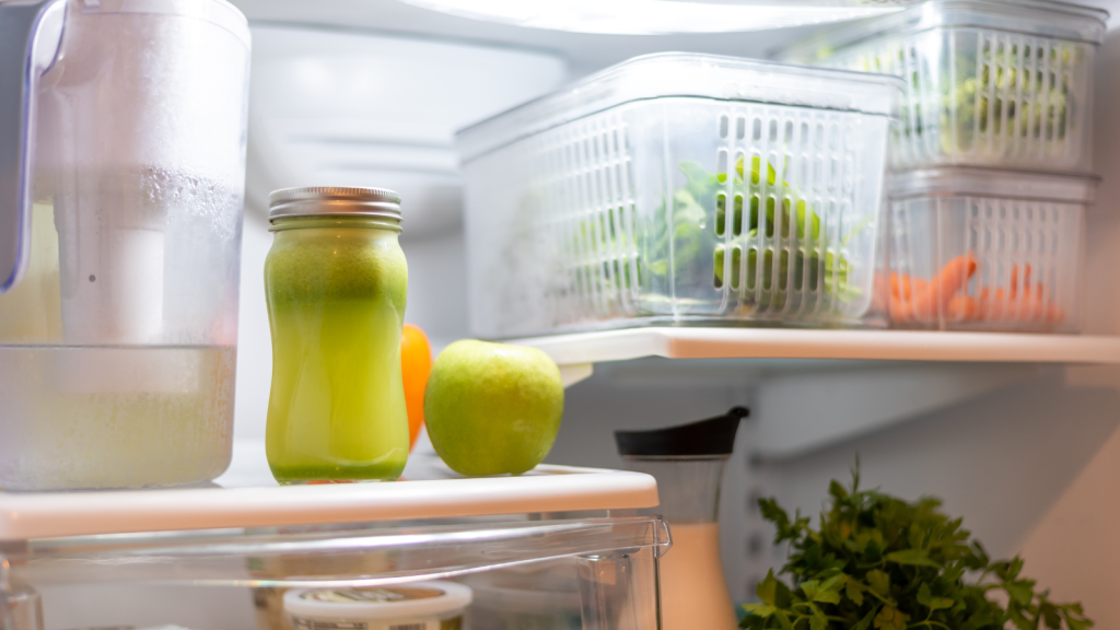 Neatly organized open refrigerator containing an assortment of fresh produce