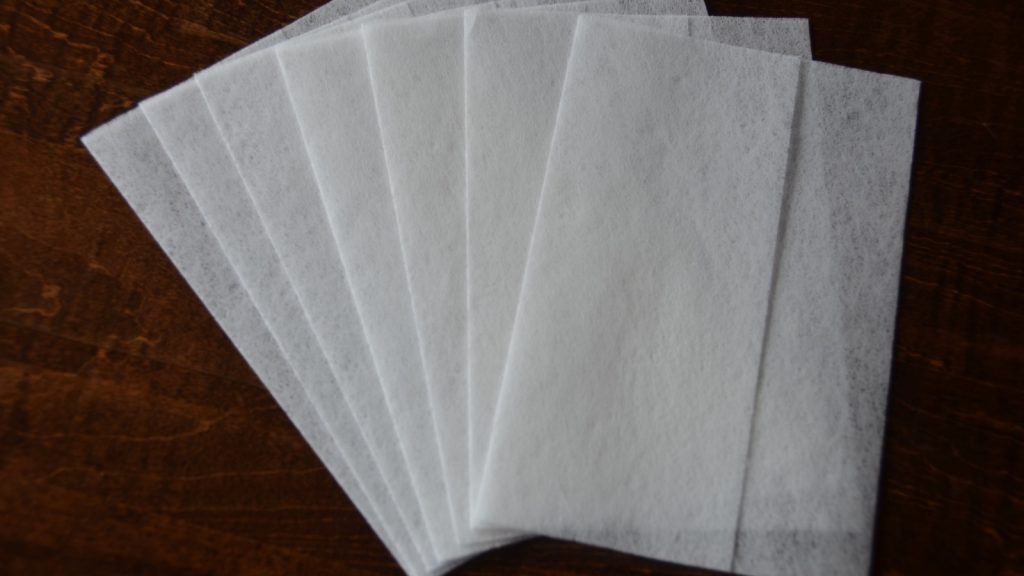 dryer sheets placed on a wooden background