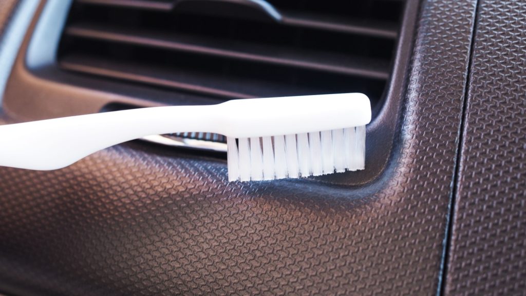 white toothbrush used for cleaning air vents