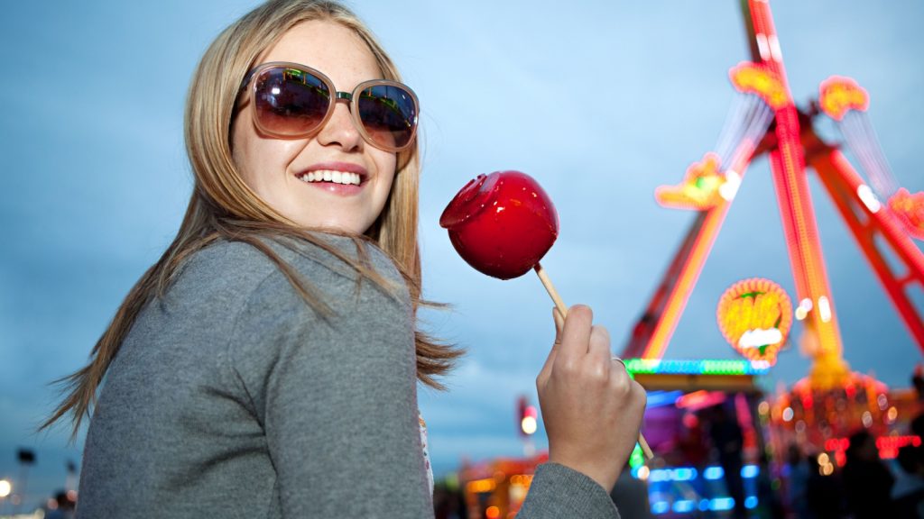 a woman eating caramel apple