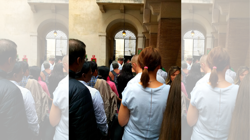 people waiting in line in the entrance of Sistine Chapel