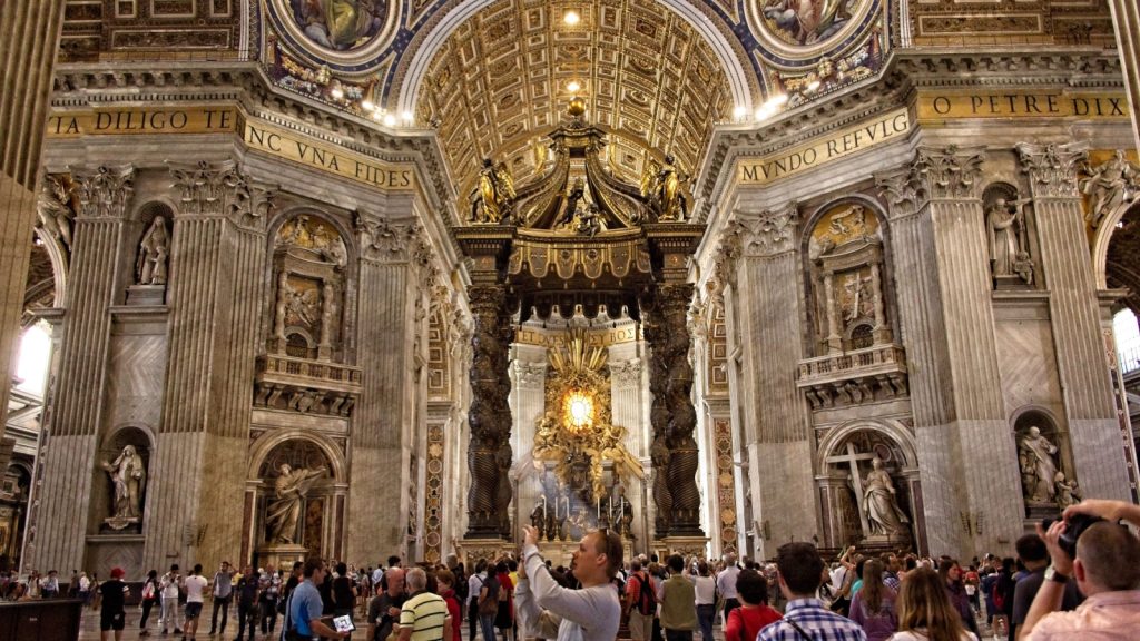 people inside sistine chapel, some of them taking photos or videos