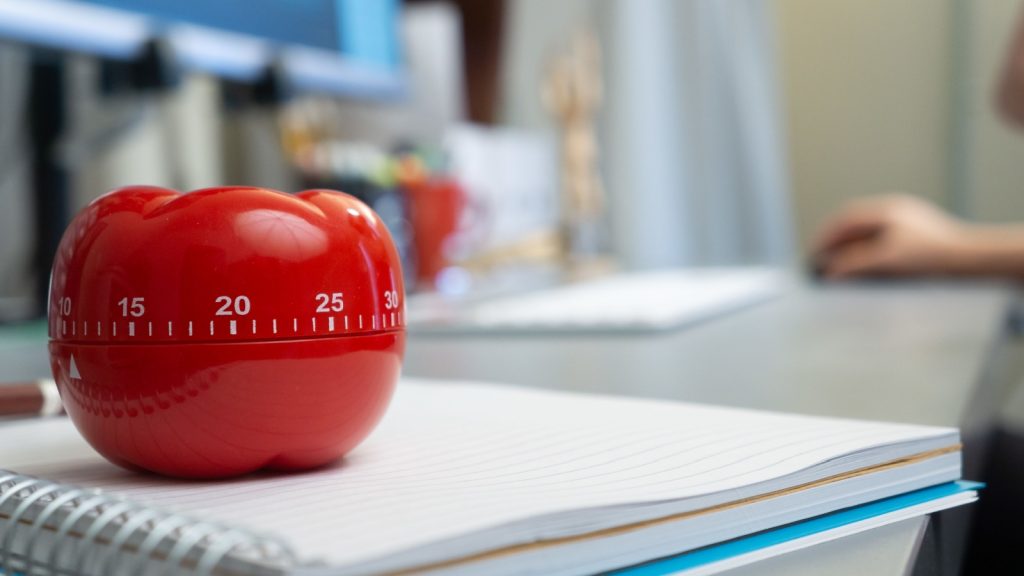 A closeup shot of a pomodoro cycle on a notebook