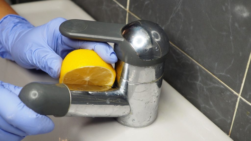 cleaning chrome sink stain with half lemon
