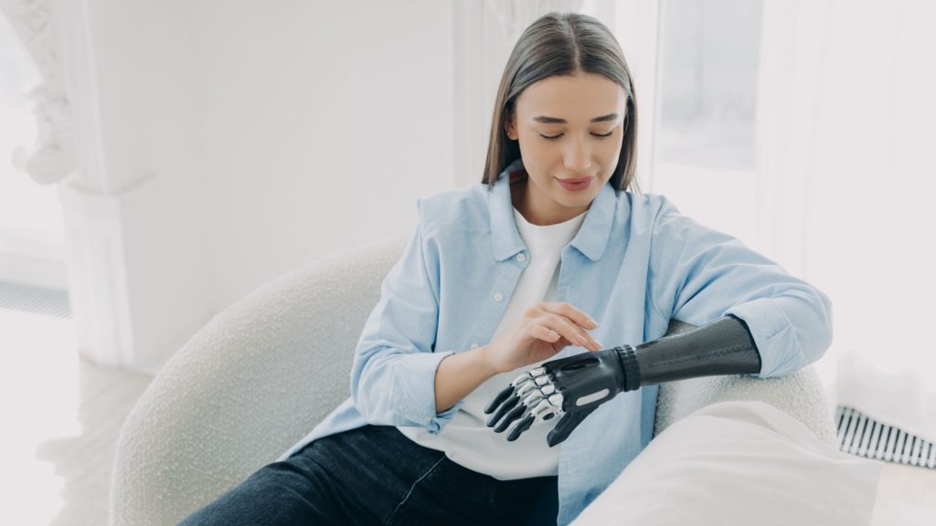 young woman touching bionic hand