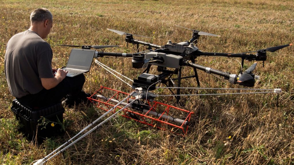 operator near mine detection drone in the field