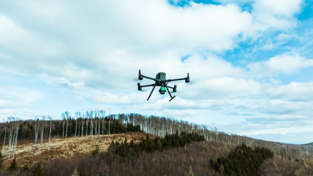 aerial view of a drone monitoring and assessing the forest after natural disaster damage