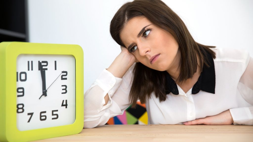 woman looking at clock
