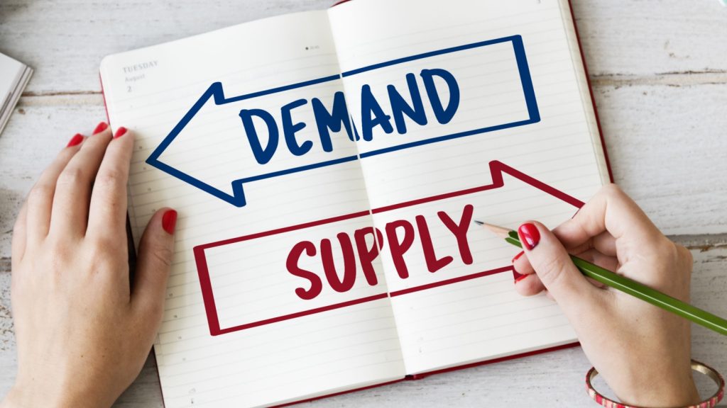 Demand Supply written on notebook
