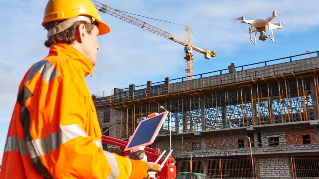 drone operated by construction worker on building site