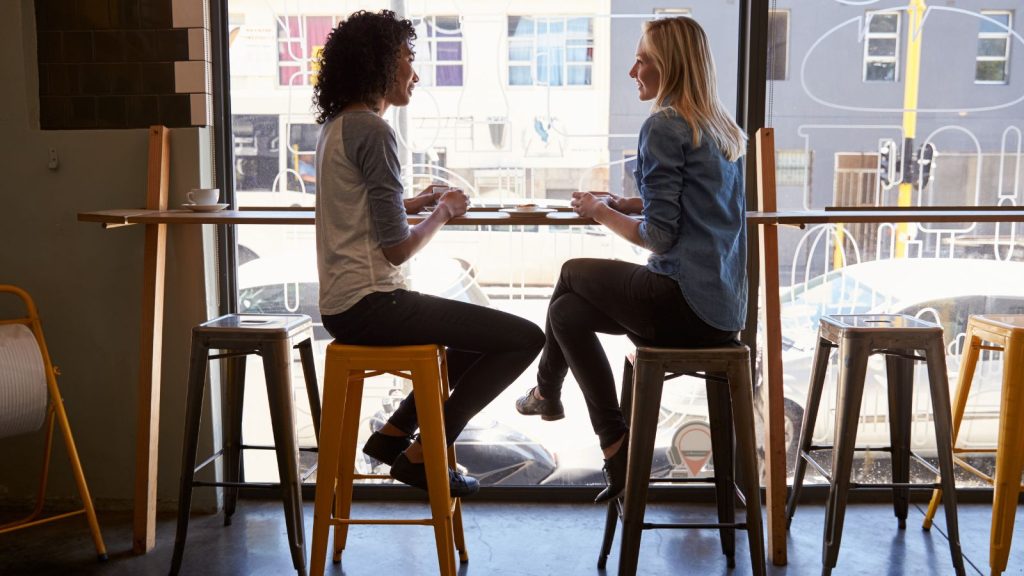 Two Female Friends Meeting In Coffee Shop